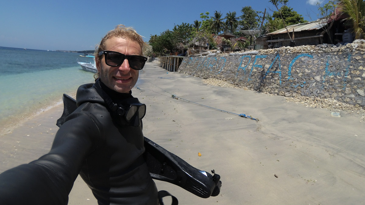 Heiko standing on a beach with his freediving gear